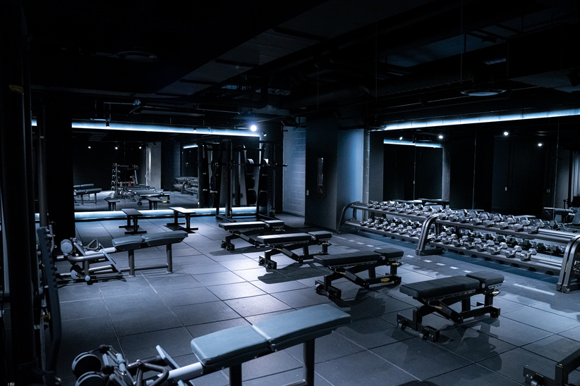 Gym amenity interior with training equipment and a running track
