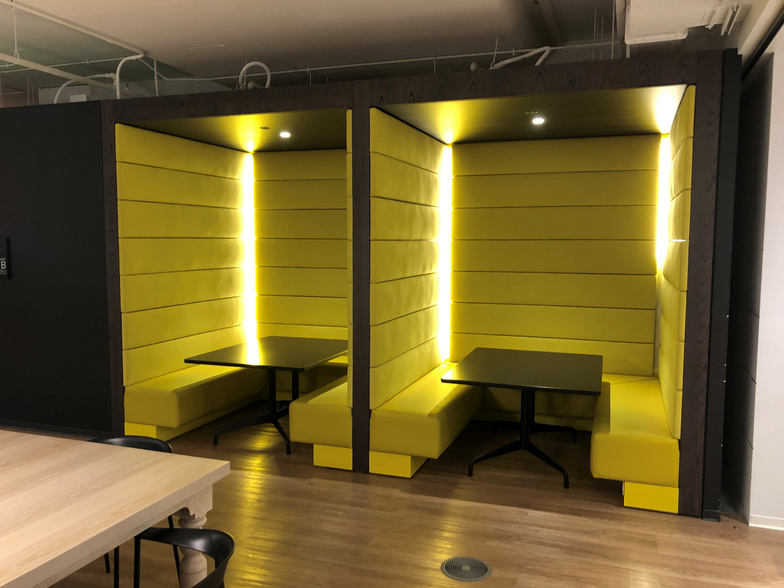 Tiered wooden seating area in an office lobby